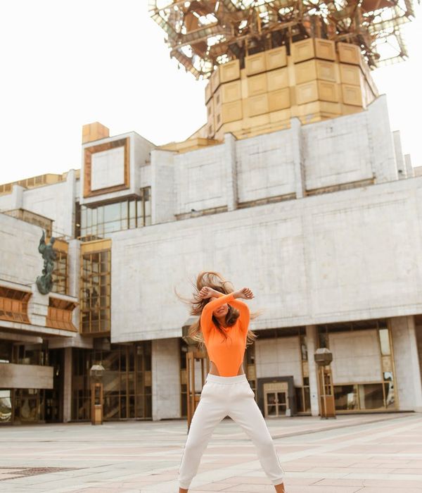 Woman feeling serene and energetic in a bright, open space.